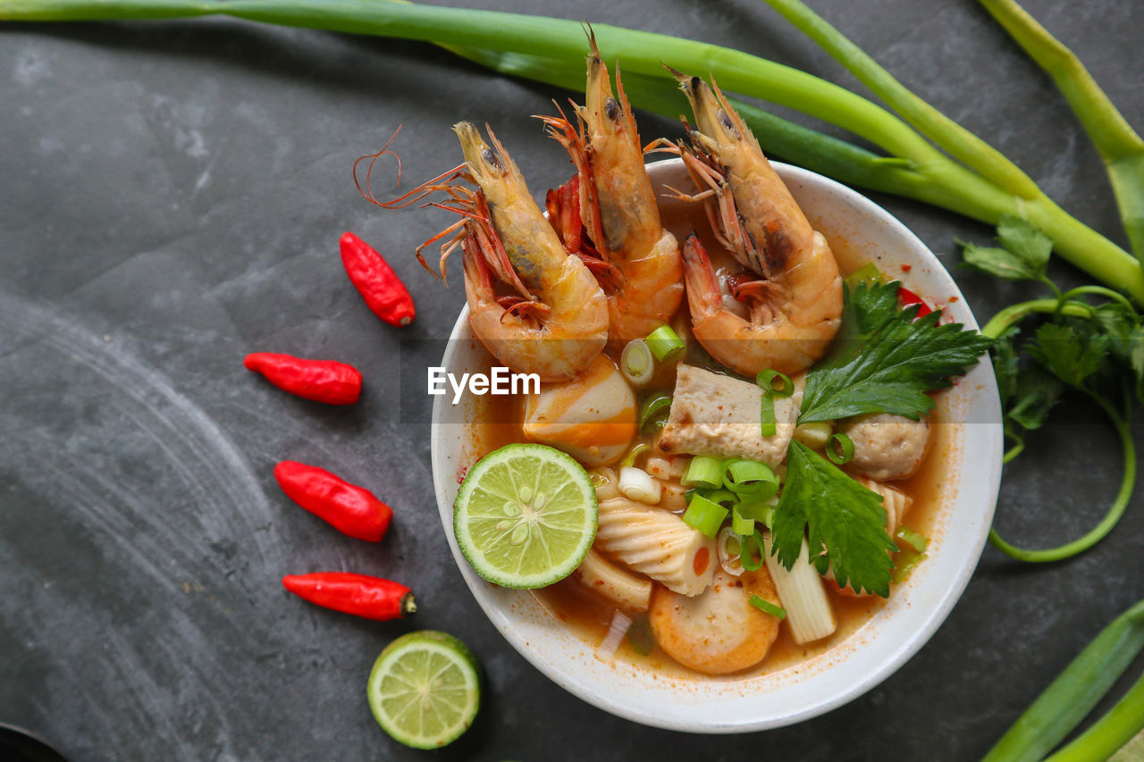 food and drink, food, healthy eating, freshness, dish, seafood, wellbeing, citrus fruit, fruit, vegetable, fish, lemon, herb, spice, shrimp, no people, high angle view, cuisine, ingredient, indoors, crustacean, meal, produce, studio shot, plate, lime, slice, animal, gourmet, chili pepper, close-up
