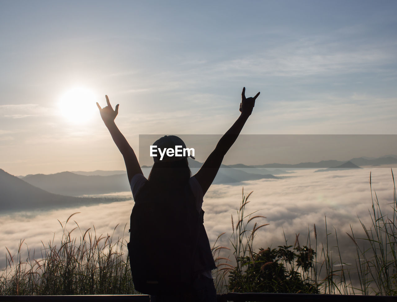 REAR VIEW OF SILHOUETTE MAN STANDING AGAINST SKY