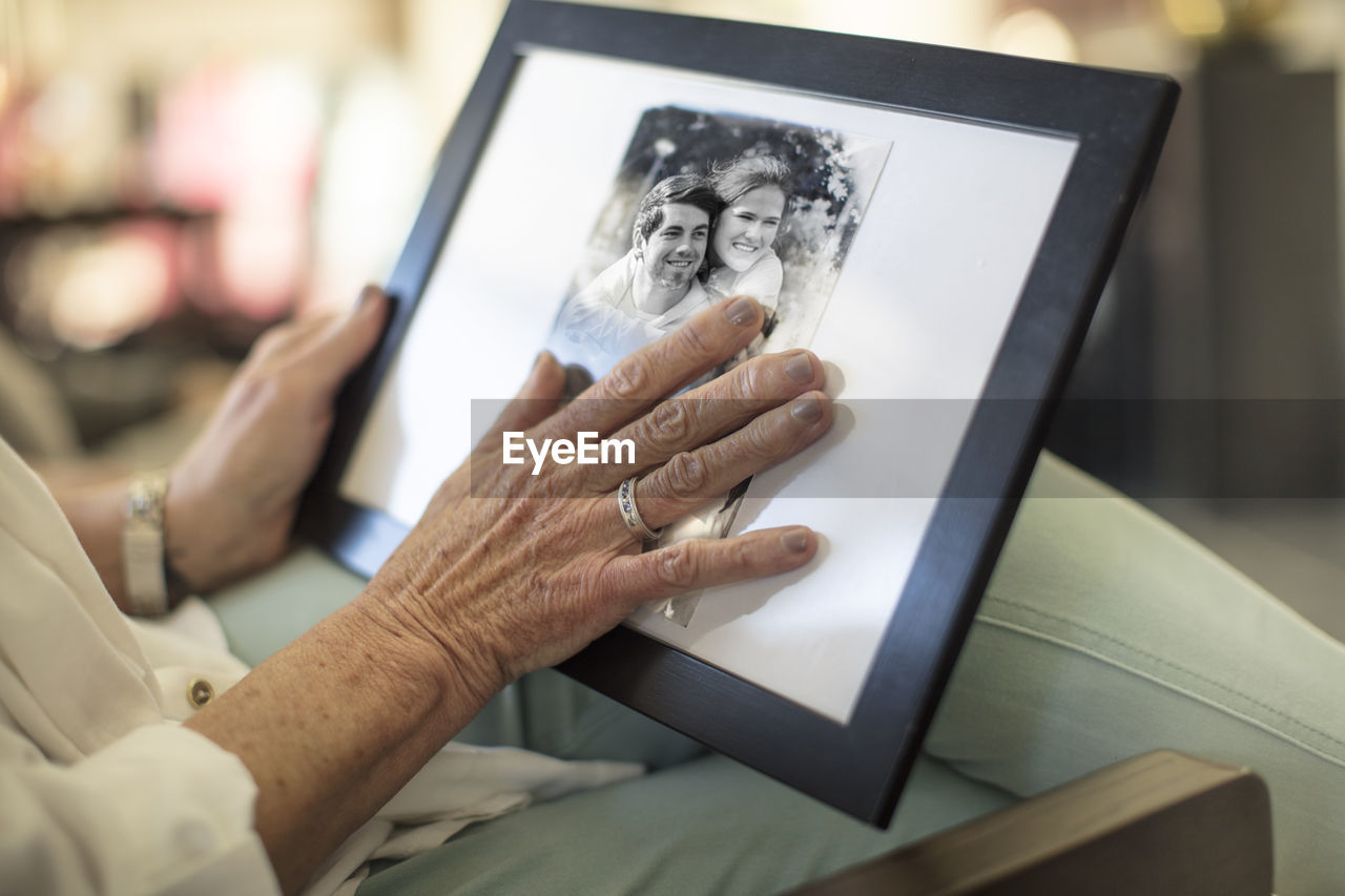 Close-up of senior woman holding a photograph