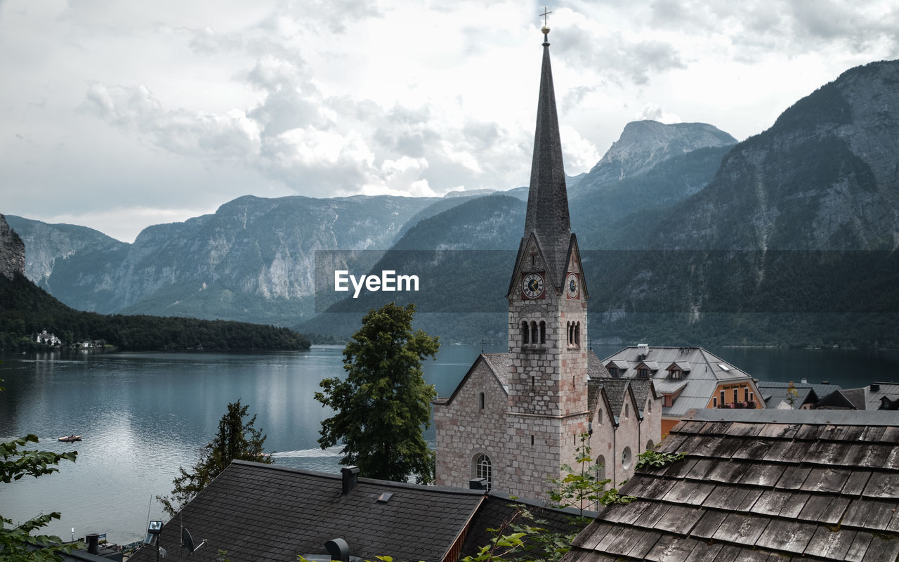 High angle view of church by lake against mountains