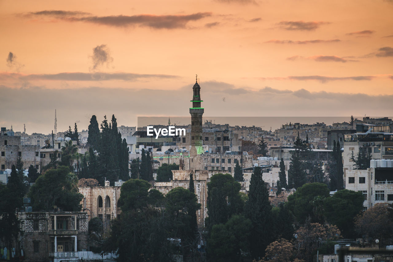 Cityscape with minaret at sunset