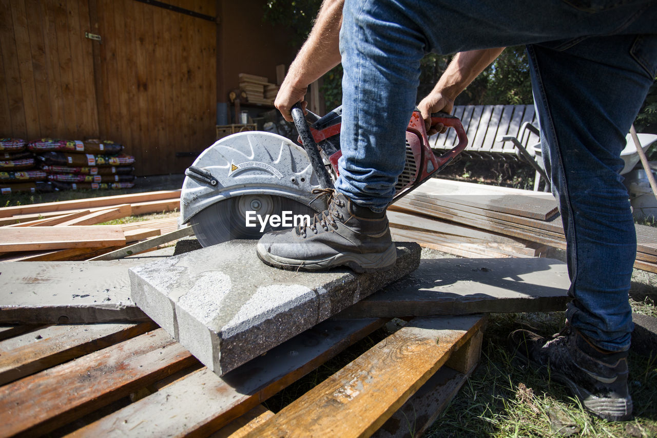 Low section of man working at construction site