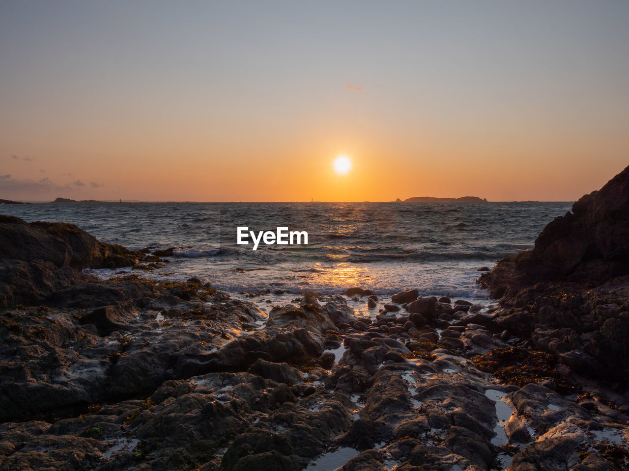 SCENIC VIEW OF BEACH DURING SUNSET