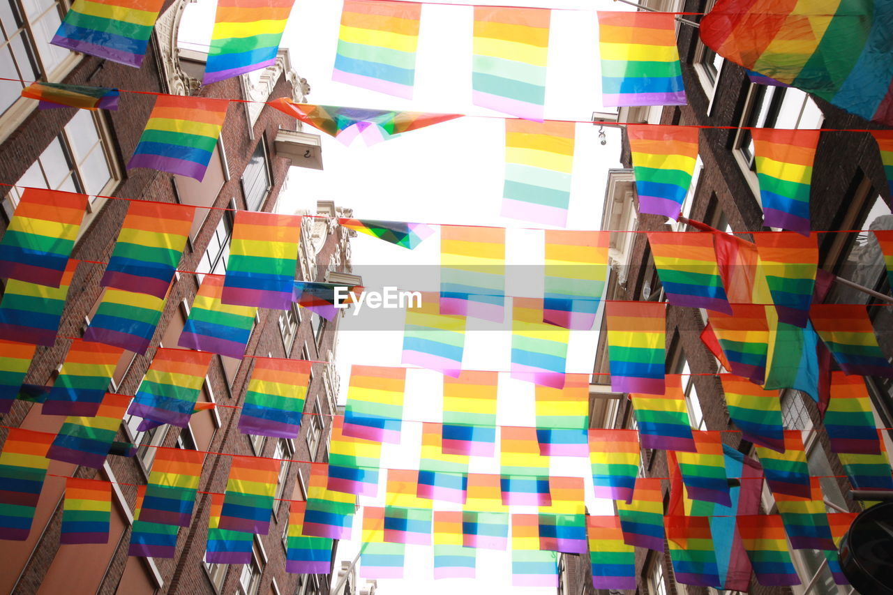 CLOSE-UP OF MULTI COLORED UMBRELLAS HANGING