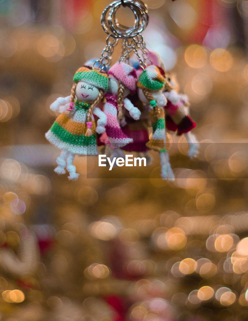 Close-up of key ring with human representation hanging for sale at market