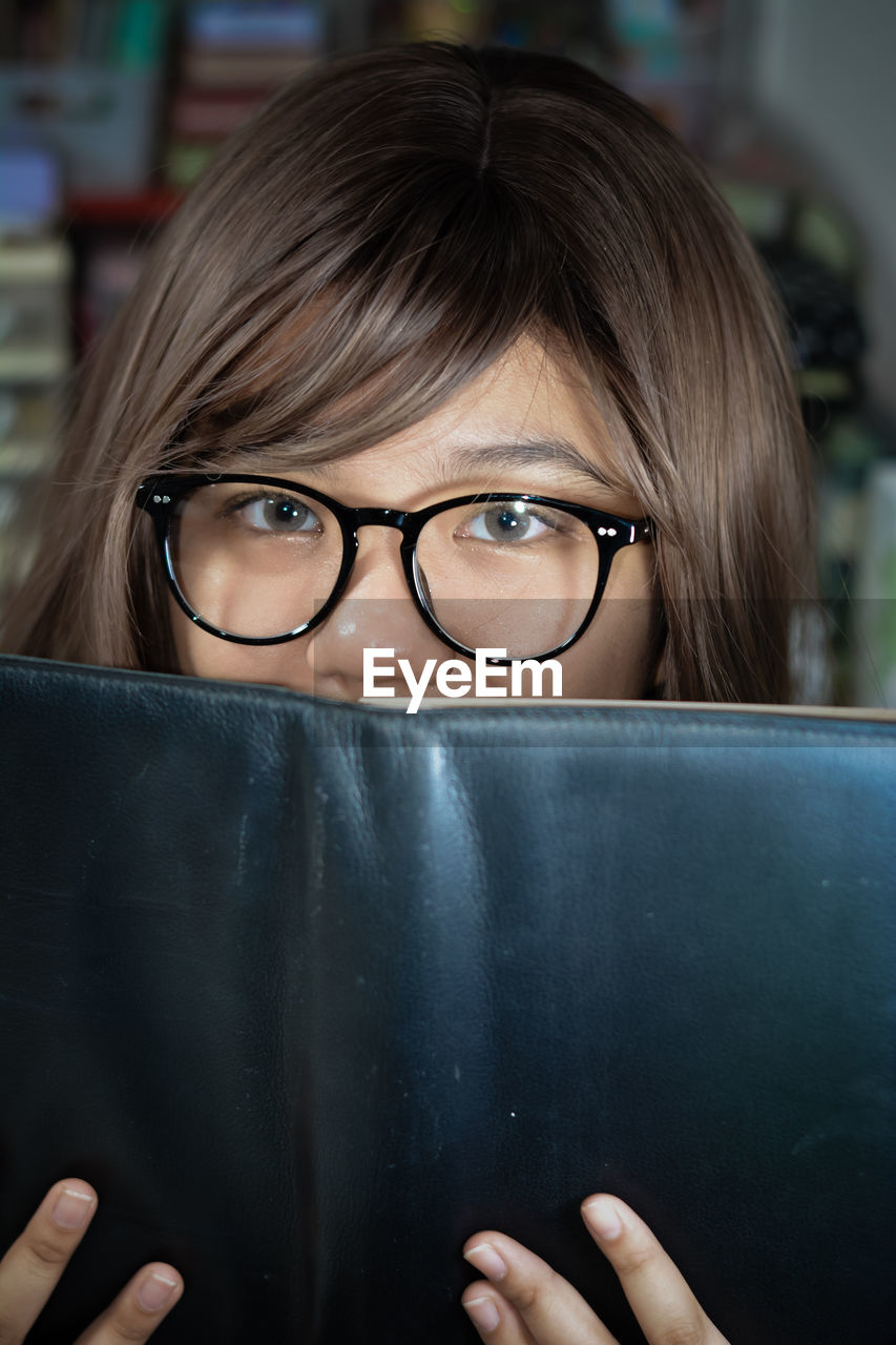 glasses, eyeglasses, vision care, one person, portrait, adult, women, headshot, looking at camera, eyewear, education, person, indoors, front view, female, young adult, human face, close-up, intelligence, child, learning, hairstyle, holding, student, emotion, human eye, business, human head, brown hair, communication