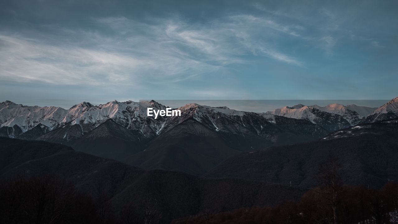 Scenic view of snowcapped mountains against sky