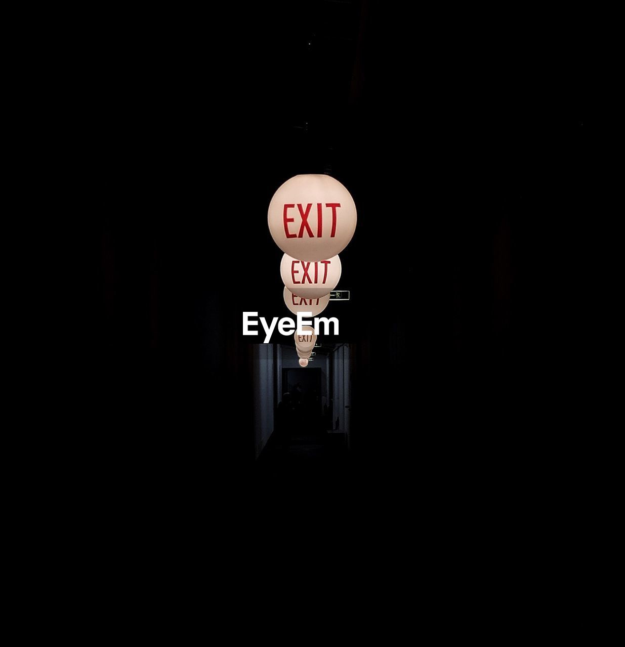 Exit text on illuminated sphere in darkroom