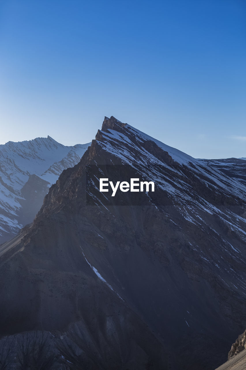 Scenic view of snowcapped mountains against clear sky