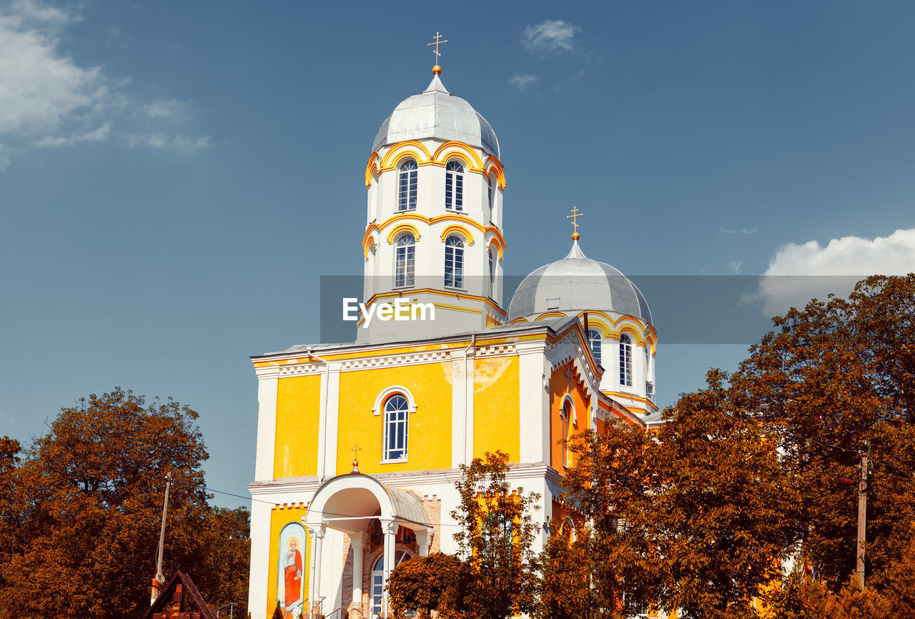 Orthodox church in autumn . monastery colored in yellow . silver dome and bell tower