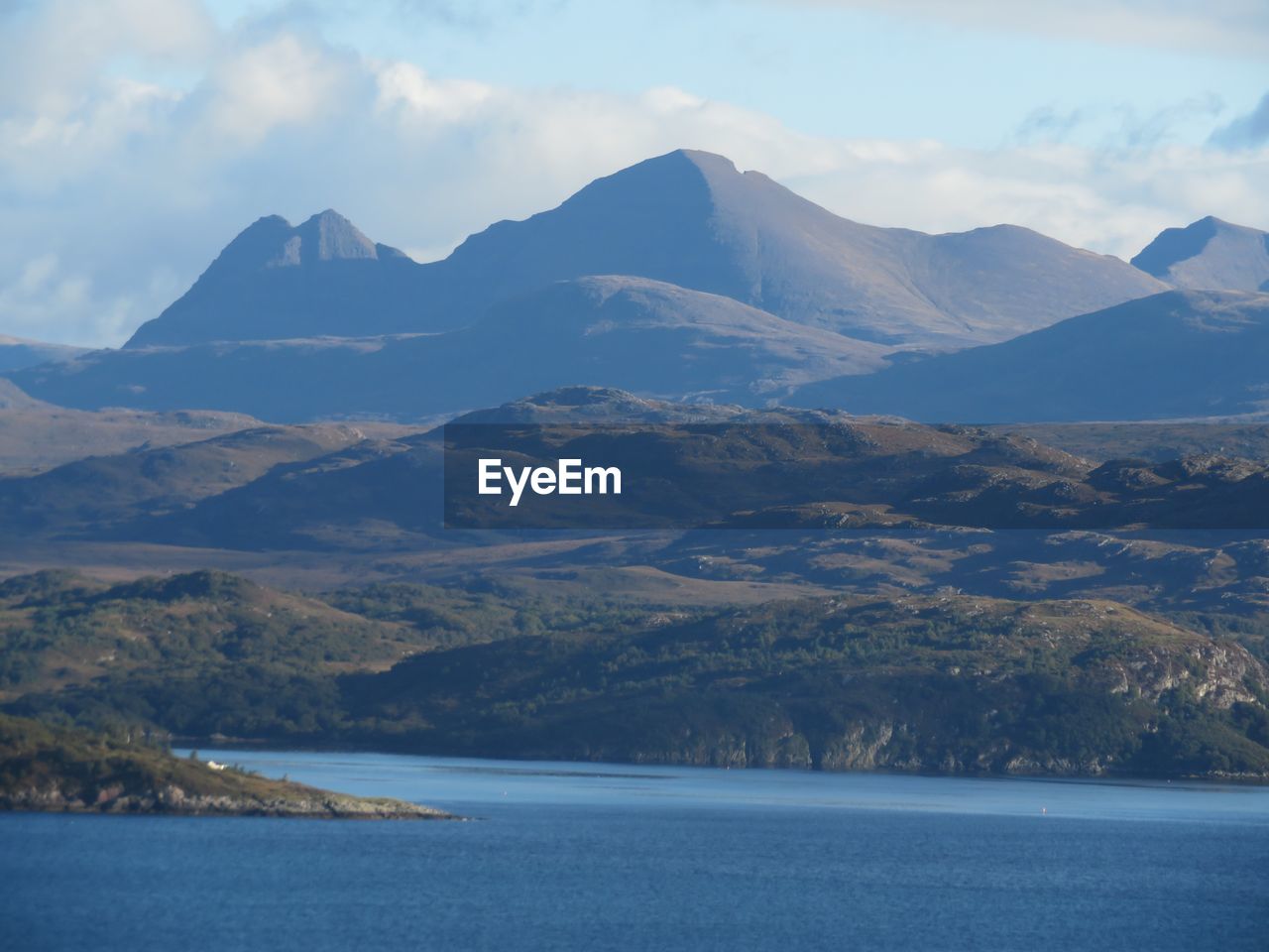 SCENIC VIEW OF MOUNTAINS AND RIVER AGAINST SKY