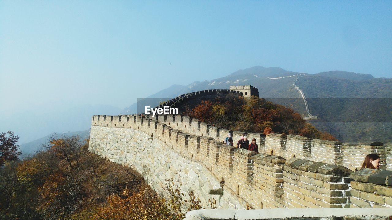 PEOPLE ON STEPS AGAINST MOUNTAIN