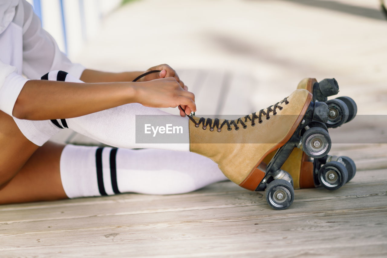 Low section of woman wearing roller skates