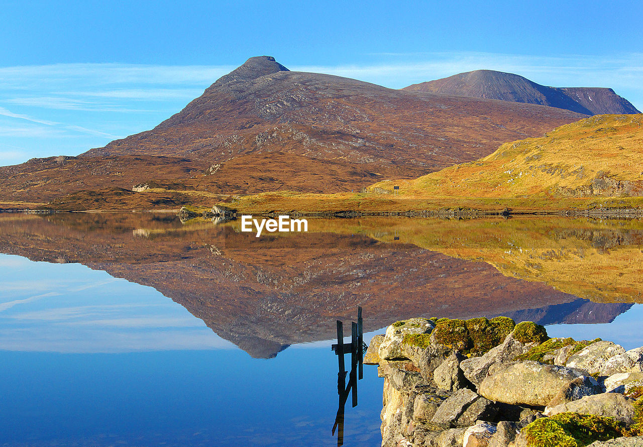 Scenic view of lake and quinag mountain against sky