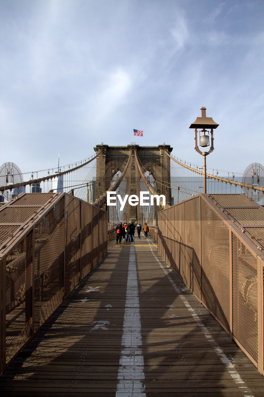 PEOPLE WALKING ON FOOTBRIDGE