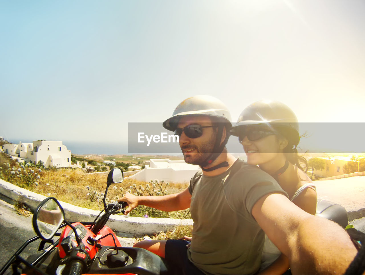 Couple on quad take a selfie. santorini island.