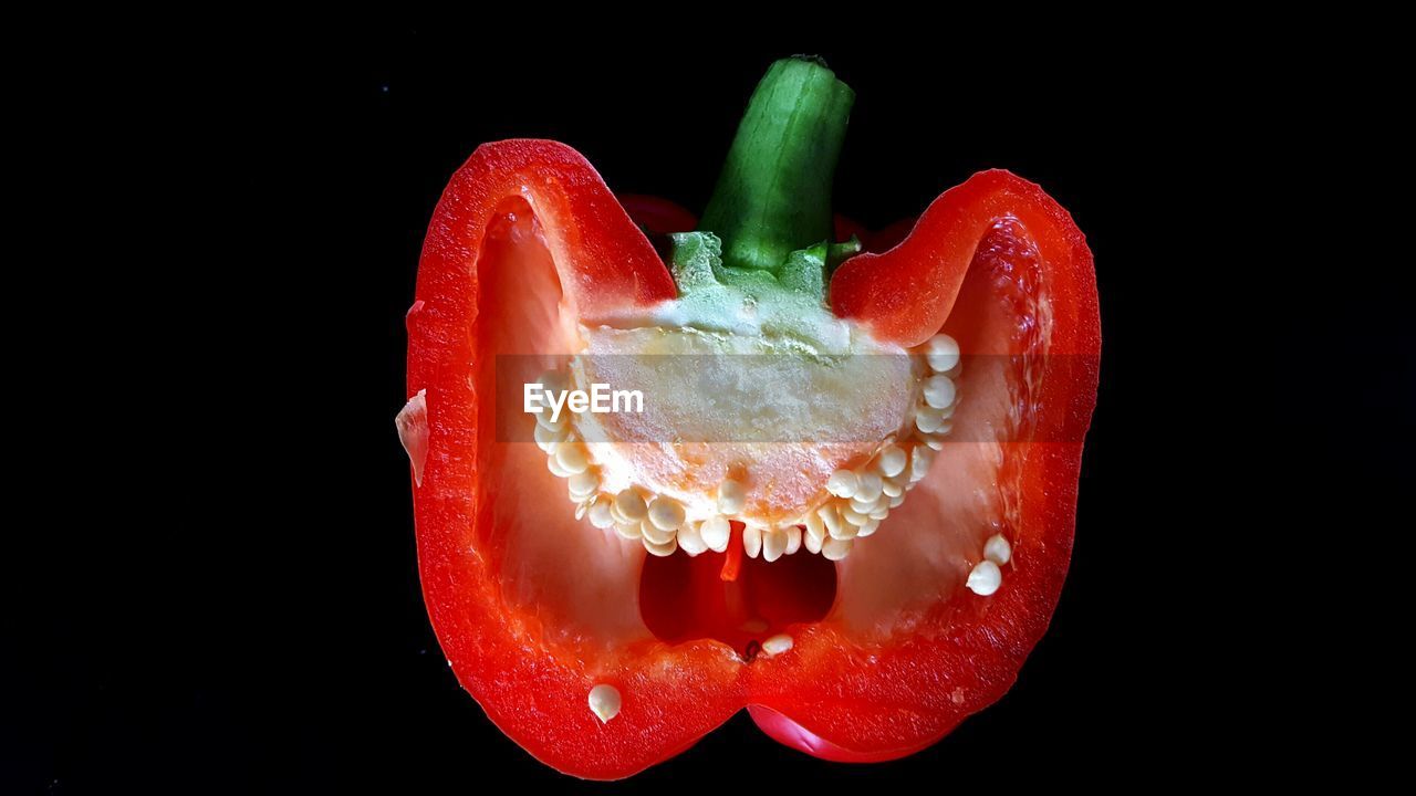 Close-up of red bell pepper over black background