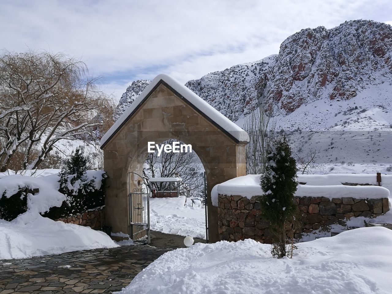 SNOW COVERED HOUSE AGAINST SKY