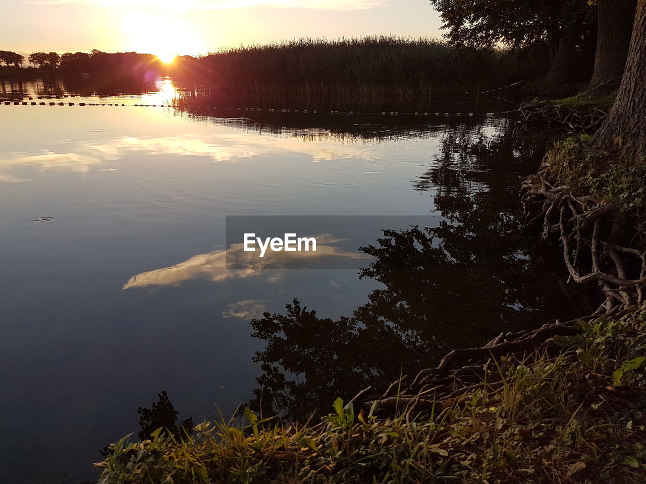 Scenic view of lake against sky during sunset