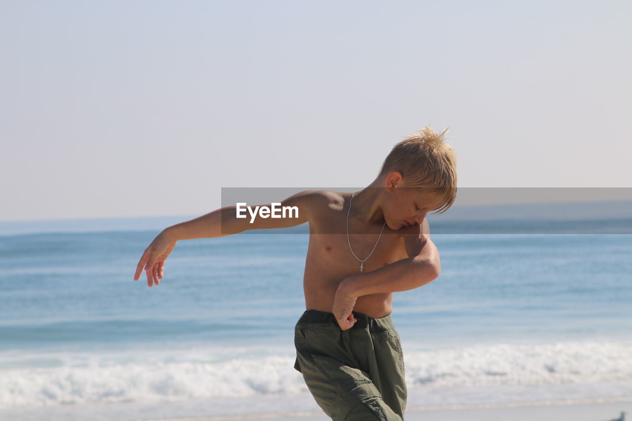 Boy dancing on beach