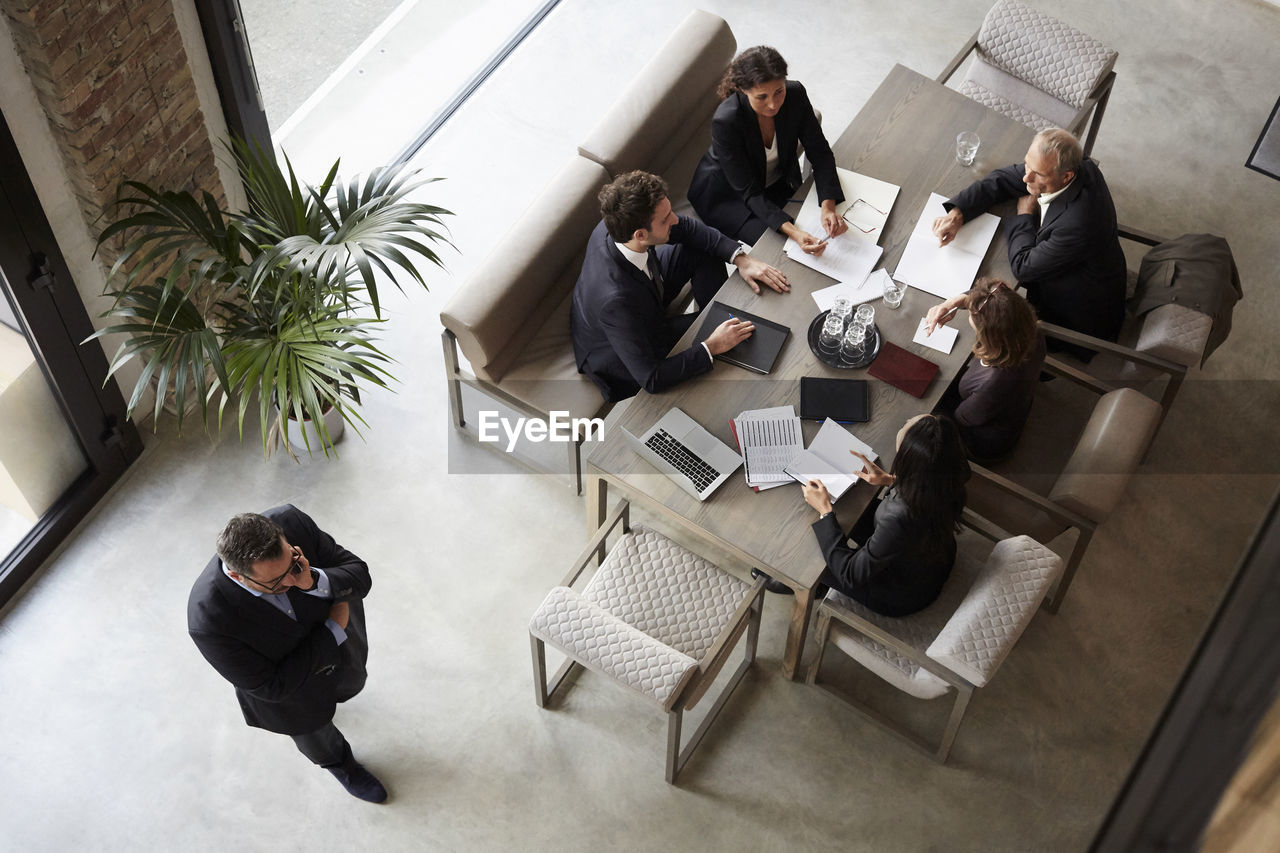 Team of financial advisors planning with business coworkers during meeting at law firm