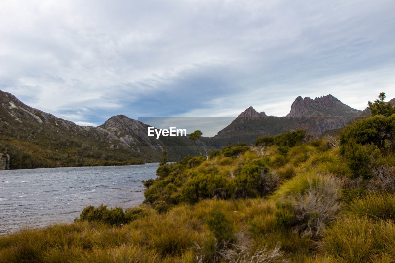 Scenic view of lake and mountains against sky
