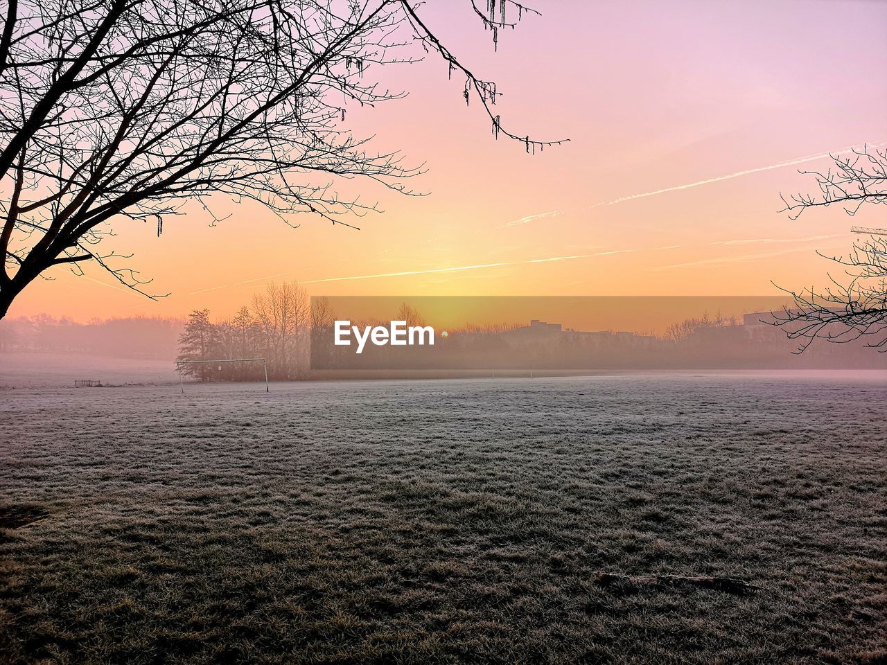 SCENIC VIEW OF BARE TREE DURING WINTER AGAINST SKY AT SUNSET