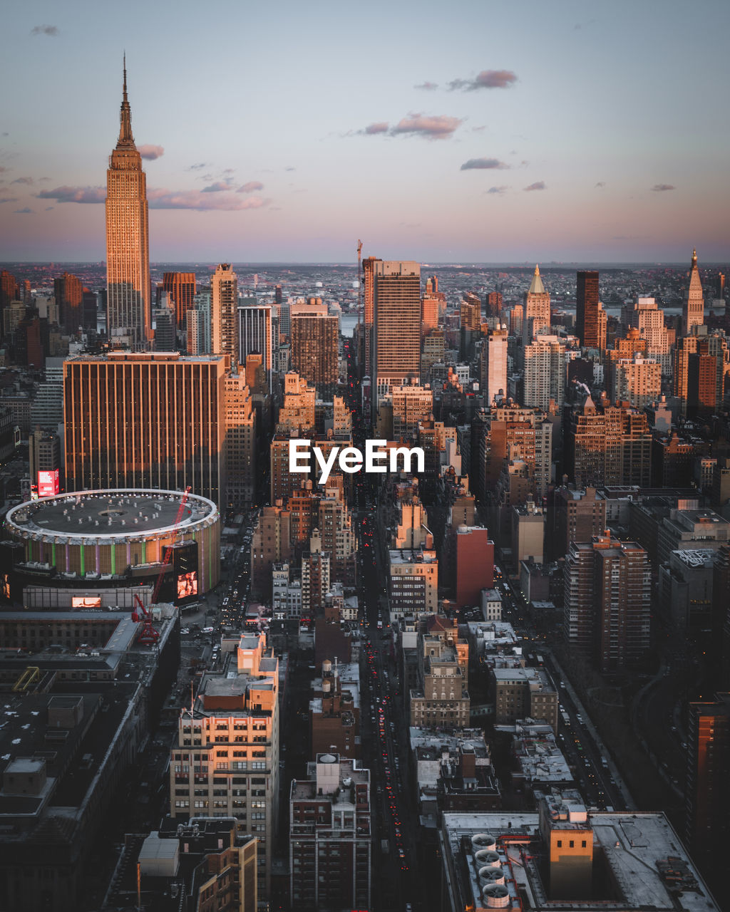 Aerial view of buildings in city during sunset