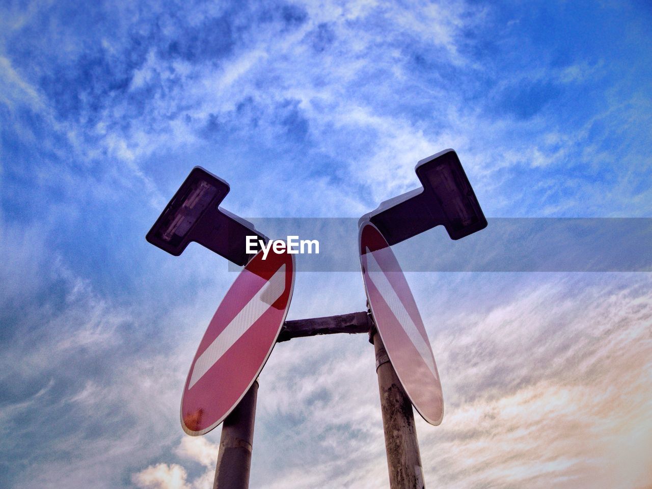 Low angle view of road sign against sky