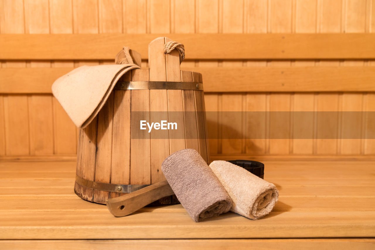 Close-up of bucket and towels in sauna