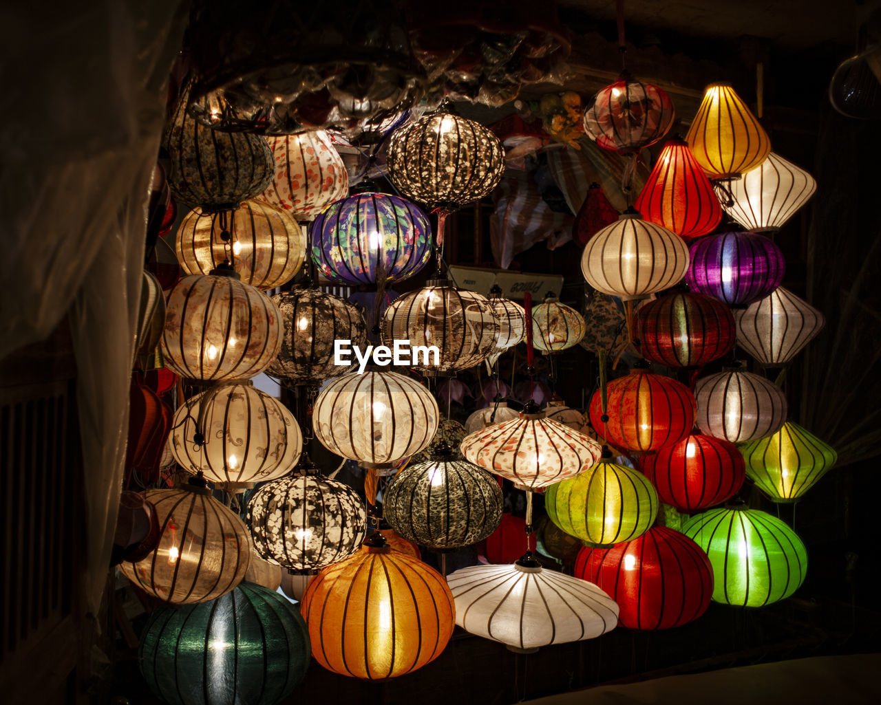 LOW ANGLE VIEW OF ILLUMINATED LANTERNS