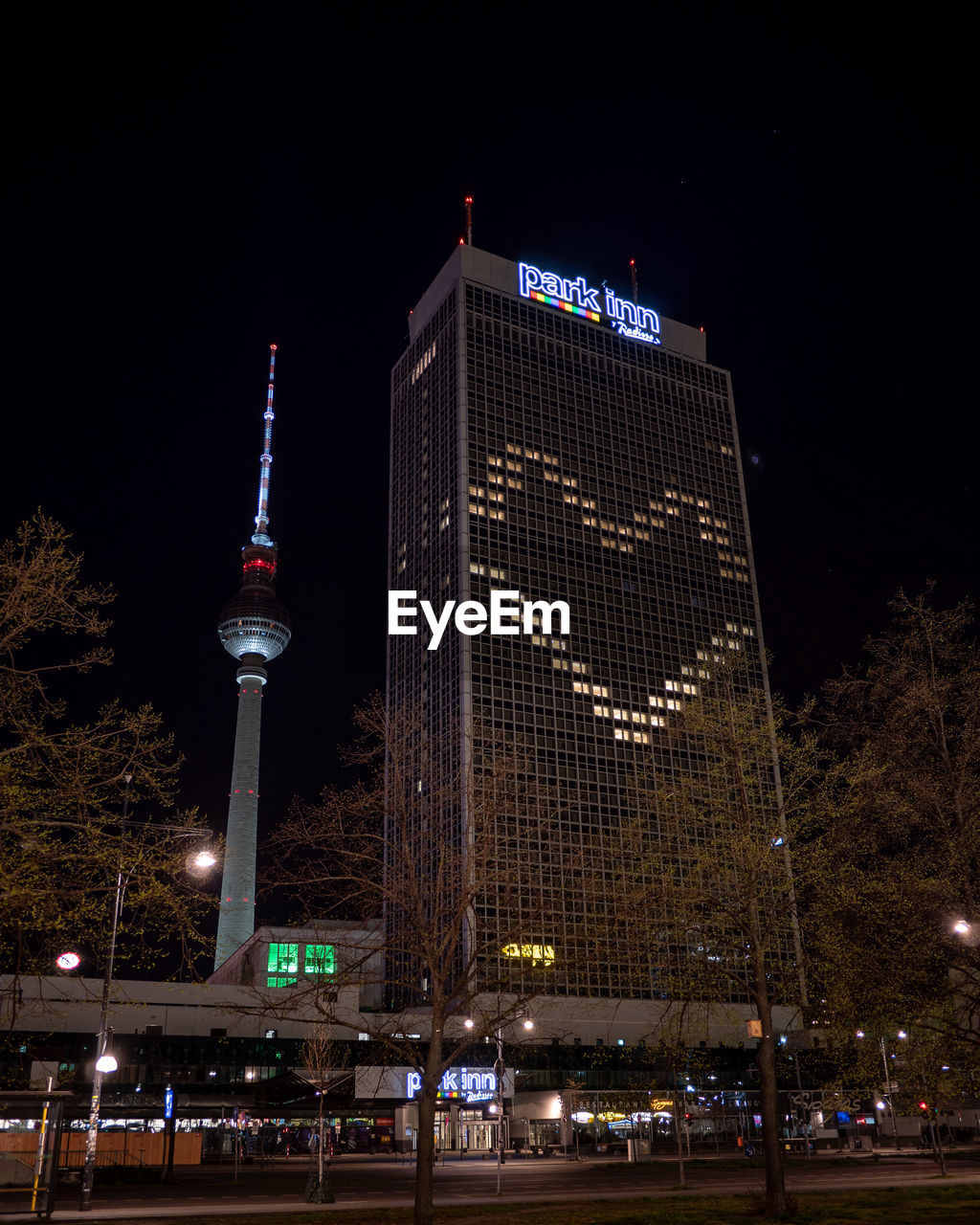 LOW ANGLE VIEW OF ILLUMINATED BUILDINGS AGAINST SKY