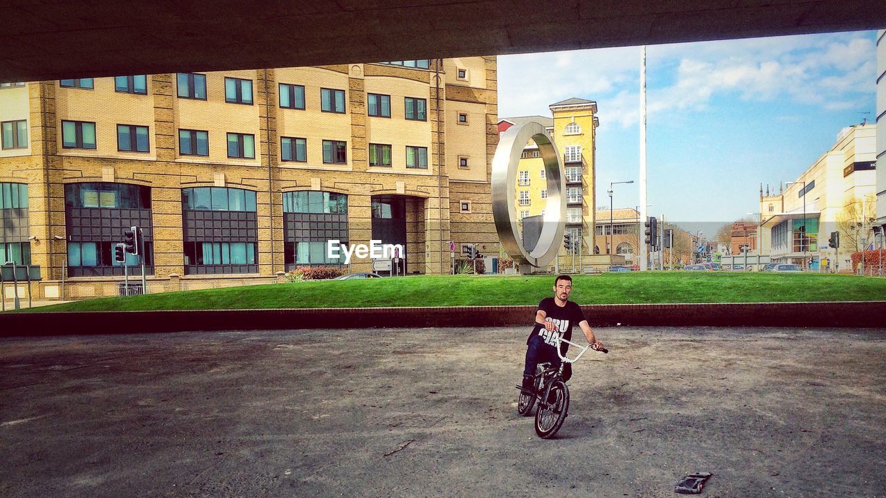 YOUNG WOMAN STANDING IN CITY