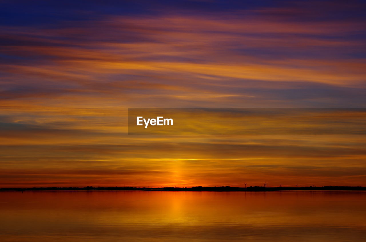 Scenic view of sea against orange sky