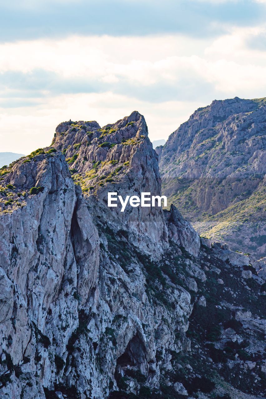 Rock formations on mountain against sky