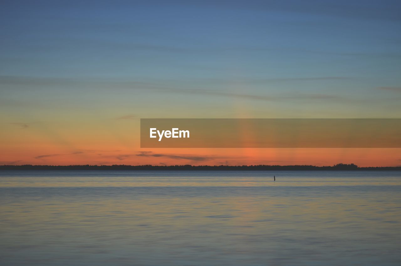 View of sea against cloudy sky during sunset