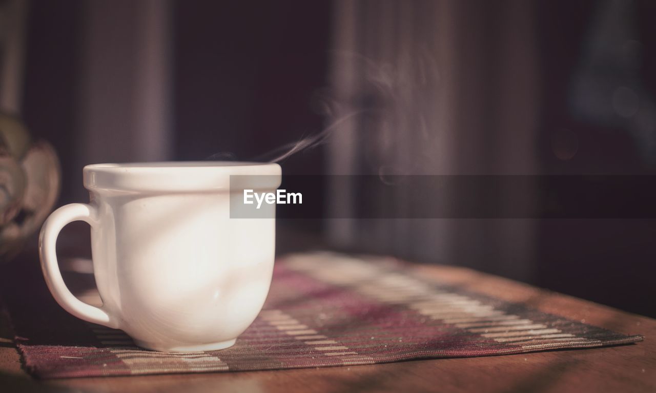 Close-up of hot tea cup on table