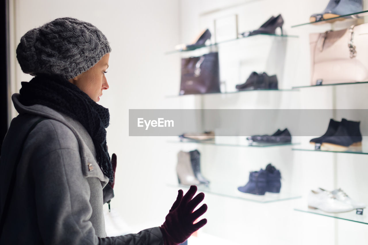 Mid adult woman standing in retail store