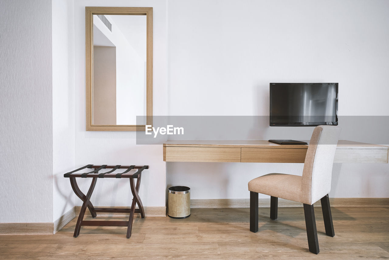 Empty chair and table in living room at home