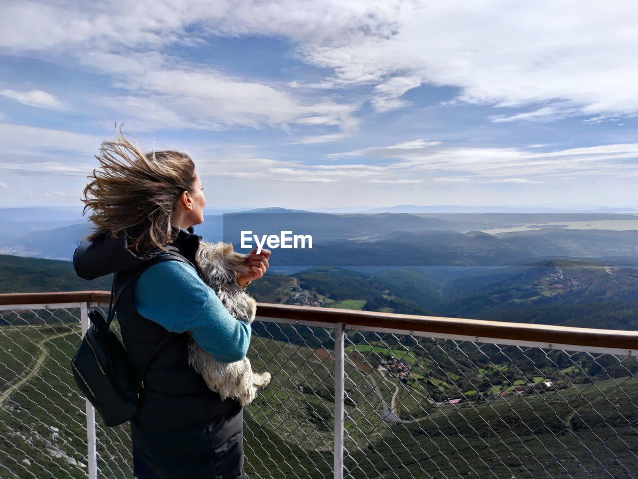 Woman standing on mountain against sky