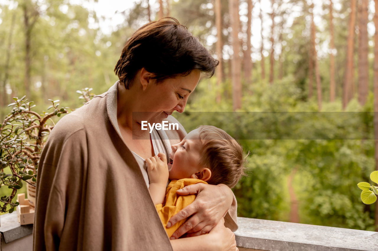 Happy grandmother and grandson enjoy time together. positive middle age woman 