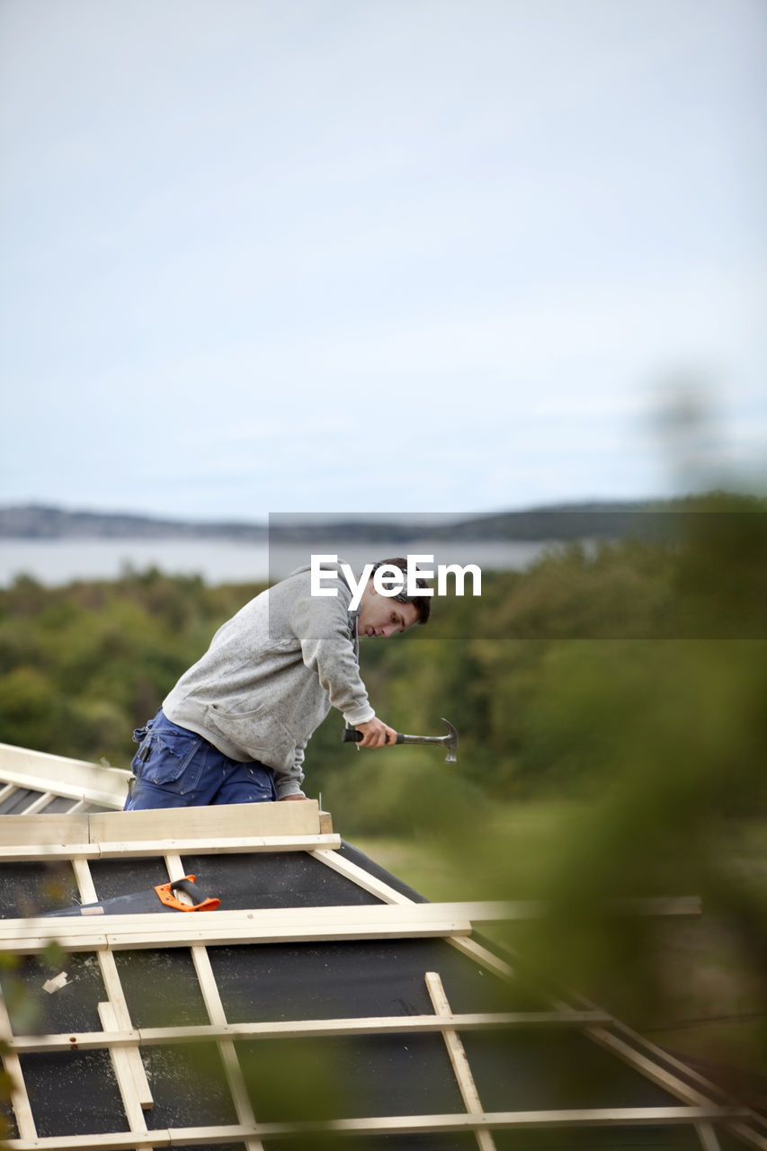 Man working on house roof