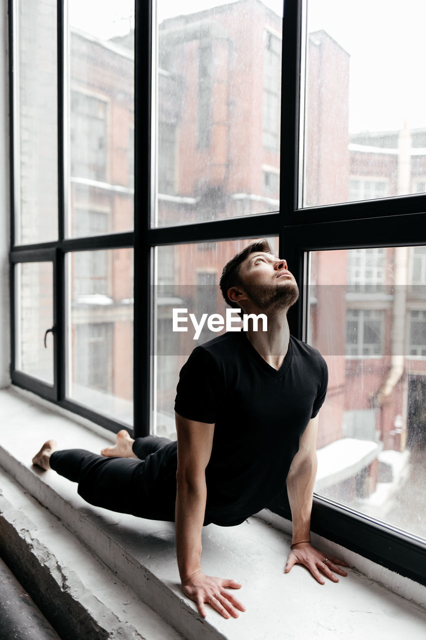 A man engaged in yoga and meditation, performing asanas