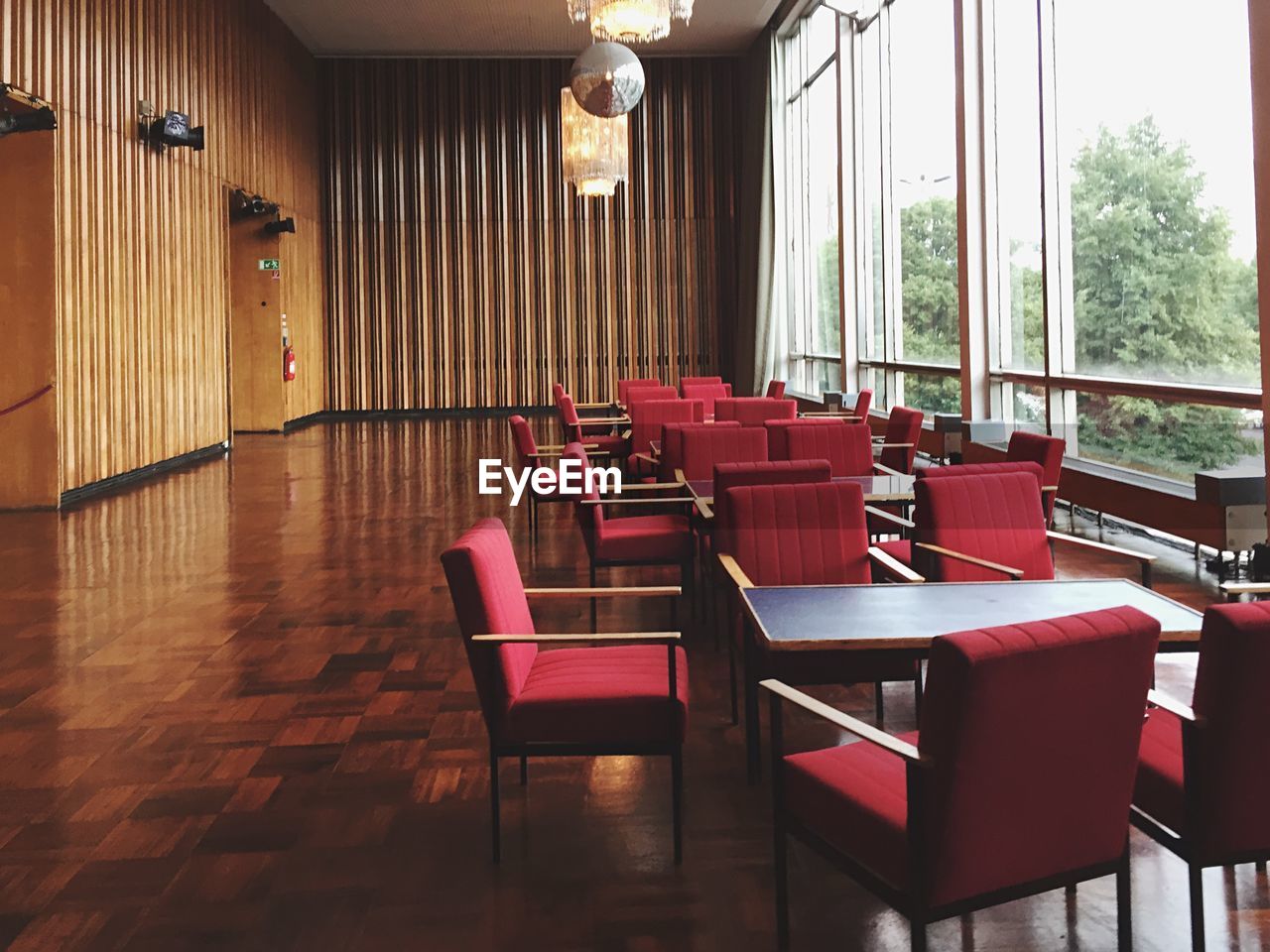 Empty chairs and tables by window in kino international