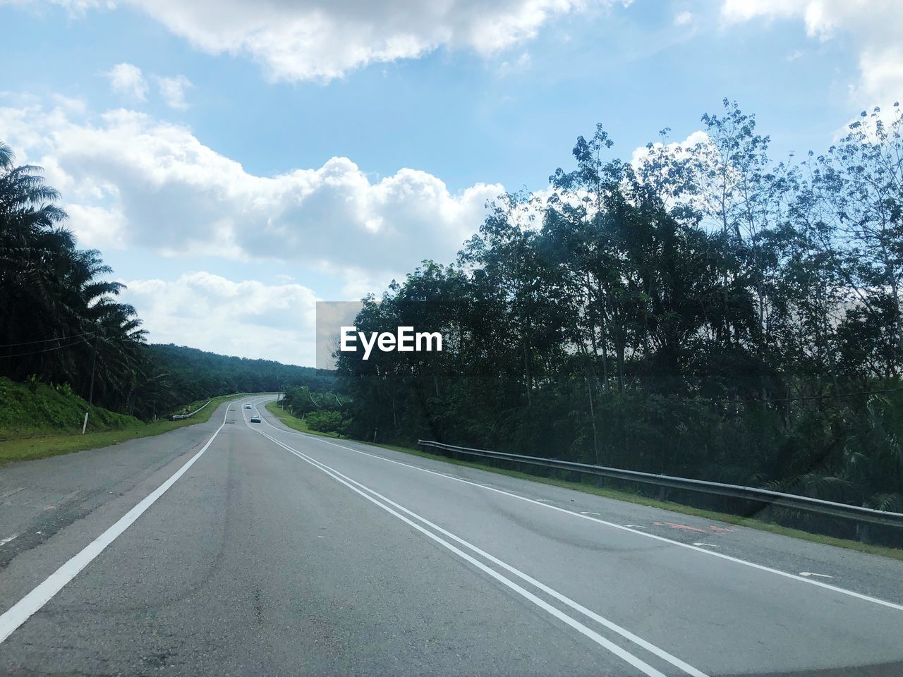 ROAD AMIDST TREES AGAINST SKY