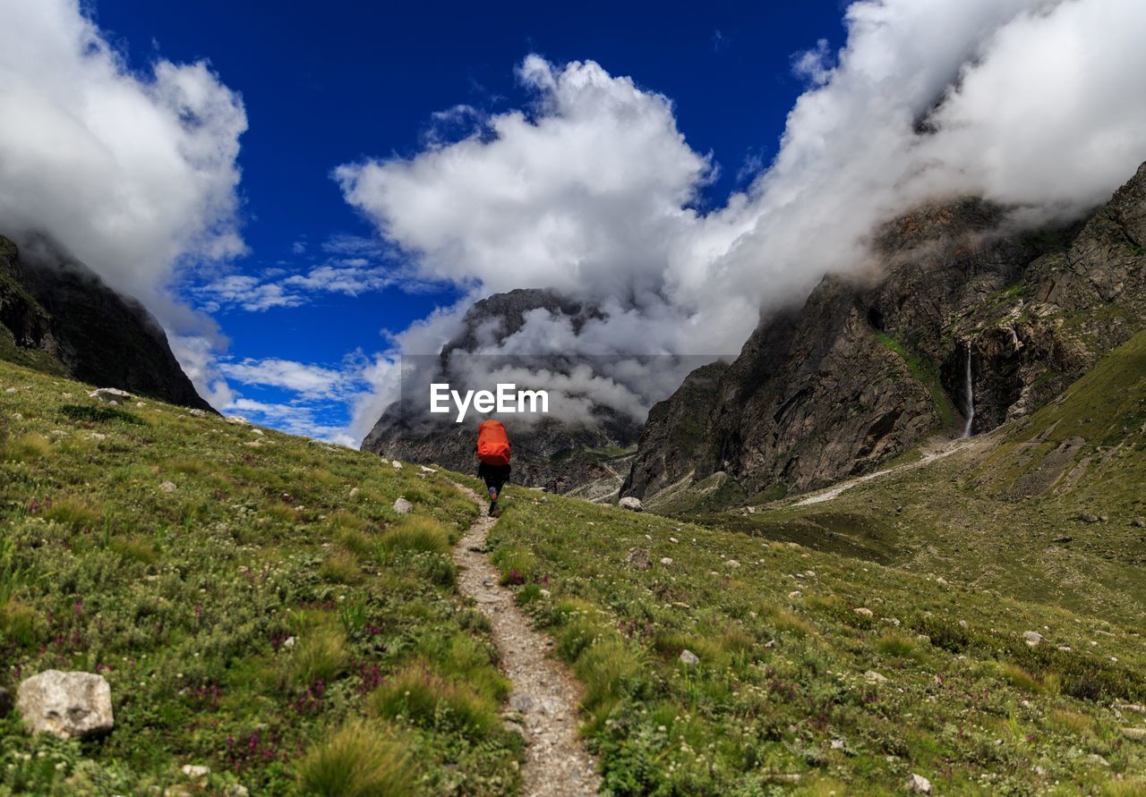 Rear view of person on mountain against sky