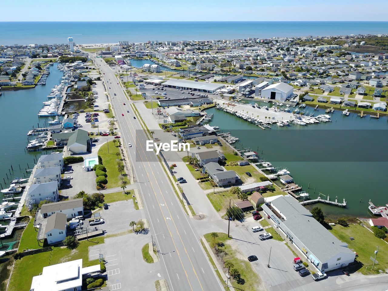 High angle view of cityscape amidst sea against sky