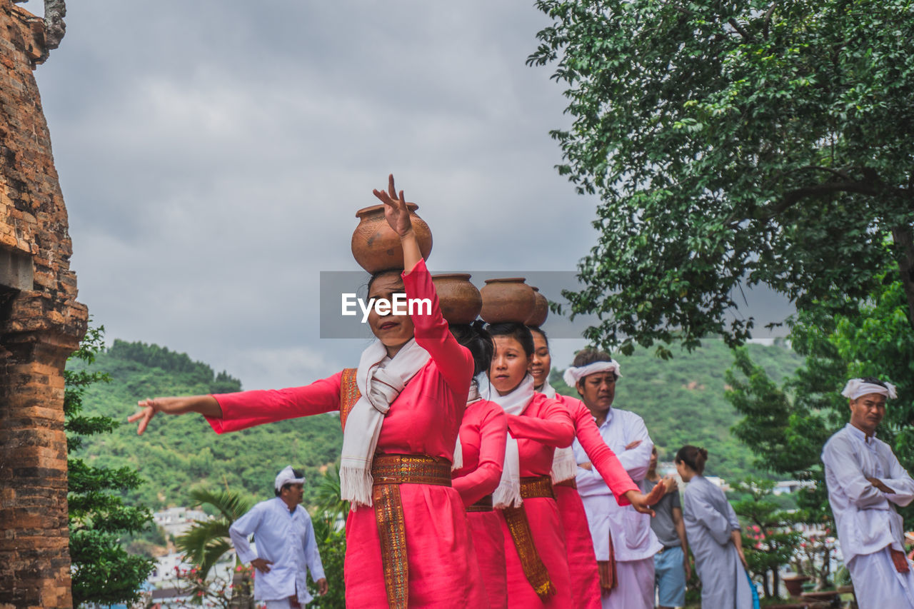 REAR VIEW OF PEOPLE AT PARK