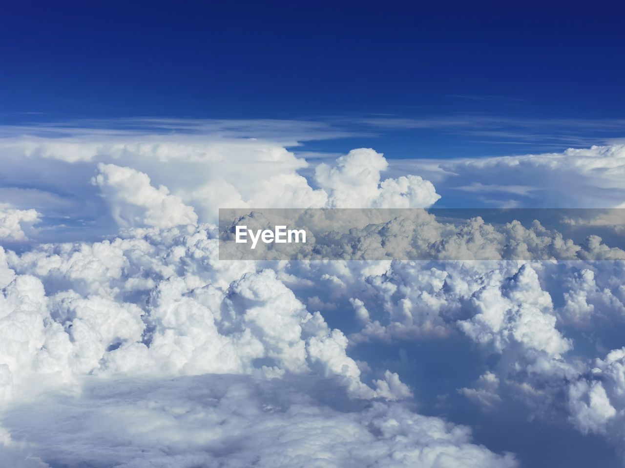 sky, cloud, aerial view, blue, cloudscape, environment, nature, beauty in nature, horizon, scenics - nature, white, no people, atmosphere, mountain range, outdoors, landscape, idyllic, airplane, fluffy, day, high up, backgrounds, high angle view, plain, tranquility, mountain, tranquil scene, flying, daytime, copy space, travel, above, dramatic sky, air vehicle