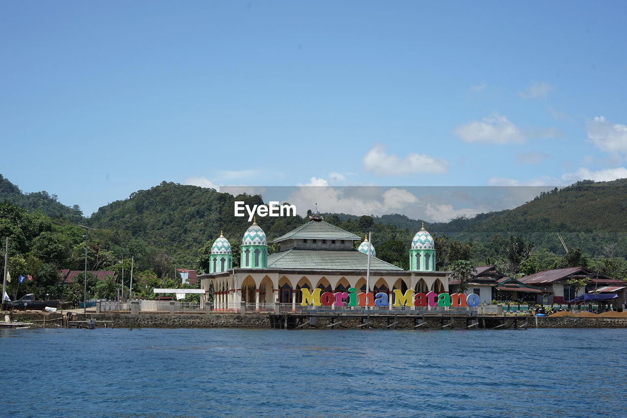 water, architecture, sky, built structure, sea, vacation, building exterior, mountain, travel destinations, nature, building, travel, tourism, bay, religion, waterfront, day, blue, land, tree, vehicle, city, body of water, no people, outdoors, transportation, coast, house, belief, tradition, trip, scenics - nature, place of worship, landscape, beach, holiday, plant, clear sky, cloud, nautical vessel, beauty in nature, environment, mountain range, boating